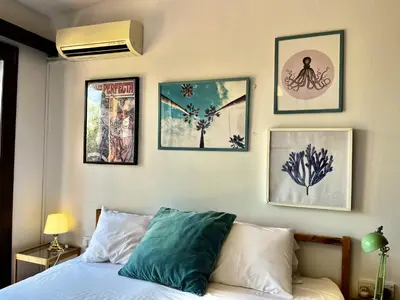 a bedroom with a bed with pictures on the wall at STAY Perla House in Protaras