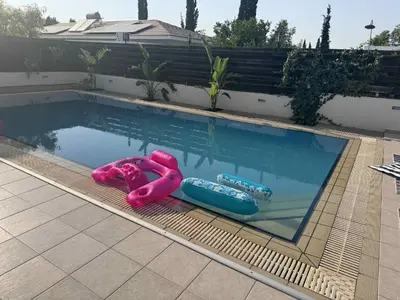 a swimming pool with inflatables in the water at Dali Villa in Dhali