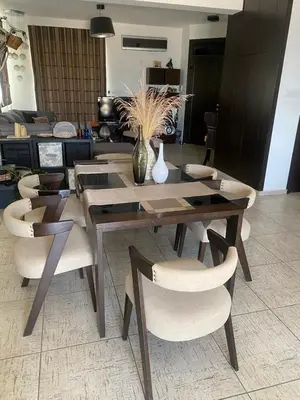 a dining room table and chairs with a vase on it at Dali Villa in Dhali
