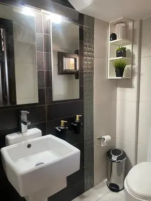 a bathroom with a white sink and a toilet at Dali Villa in Dhali