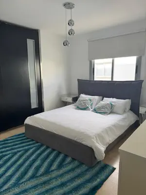 a bed with two pillows on it in a bedroom at Blue Tulip - Strovolos in Kato Lakatamia