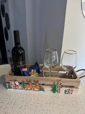 a bottle of wine and two glasses on a table at Blue Tulip - Strovolos in Kato Lakatamia