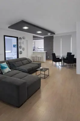 a living room with a couch and a table at Blue Tulip - Strovolos in Kato Lakatamia