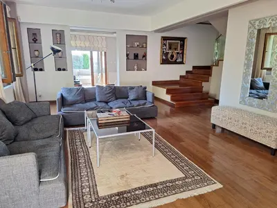 a living room with a blue couch and a table at Live in landlord guest house panthea in Limassol
