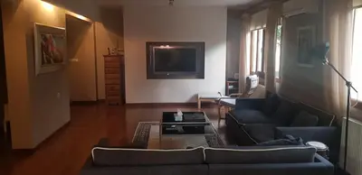 a living room with a couch and a tv at Live in landlord guest house panthea in Limassol