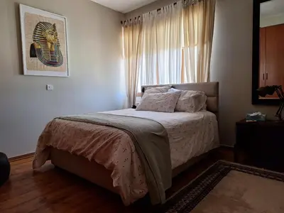a bedroom with a bed and a window at Live in landlord guest house panthea in Limassol
