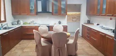 a kitchen with a table and chairs in it at Live in landlord guest house panthea in Limassol