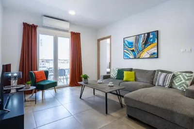 a living room with a couch and a table at Invictus 2-Bedroom Apartment in Larnaka