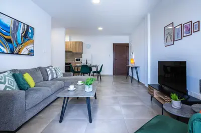 a living room with a couch and a table at Invictus 2-Bedroom Apartment in Larnaka