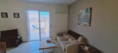 a living room with a couch and a table at STAY Sunshine Apartment in Protaras