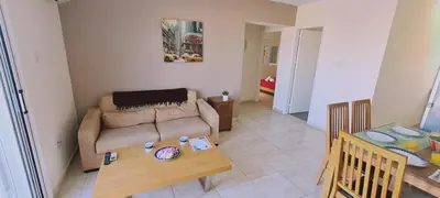a living room with a couch and a table at STAY Sunshine Apartment in Protaras
