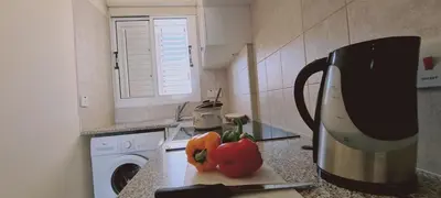 a kitchen with a counter with a mixer and some peppers at STAY Sunshine Apartment in Protaras