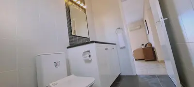 a white bathroom with a toilet and a mirror at STAY Sunshine Apartment in Protaras