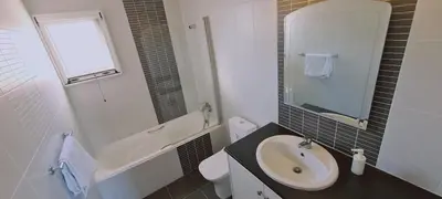 a white bathroom with a sink and a toilet at STAY Sunshine Apartment in Protaras