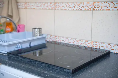 a kitchen counter with a glass counter top with a sink at ONAR mackenzie 1 in Larnaka