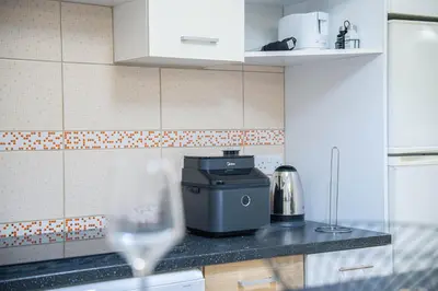 a kitchen with a counter with a wine glass at ONAR mackenzie 1 in Larnaka