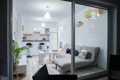 a living room with a couch and a table at ONAR mackenzie 1 in Larnaka