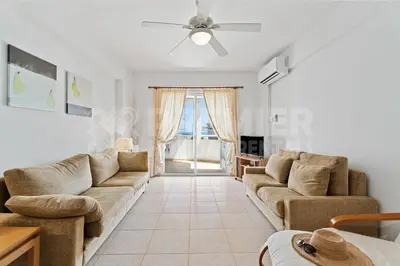 a living room with two couches and a ceiling fan at Apartment Karlota in Paralimni