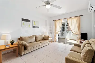 a living room with a couch and a tv at Apartment Karlota in Paralimni
