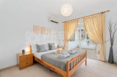 a bedroom with a bed and a large window at Apartment Karlota in Paralimni