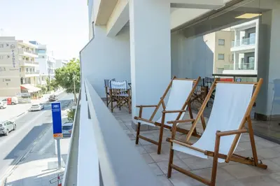 a row of chairs sitting on a balcony at Cosy & Bright European Uni Apt in Strovolos