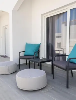 a room with two chairs and a table and a table and chairs at Nissi Pearl Seaside Residence in Ayia Napa