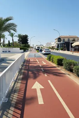 an empty street with a white arrow on a road at Nissi Pearl Seaside Residence in Ayia Napa