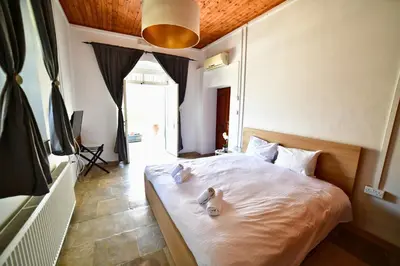 two stuffed animals sitting on a bed in a bedroom at Laouri Traditional 1-Bedroom in Kalopanayiotis in Kalopanayiotis