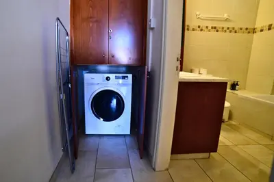a bathroom with a washing machine in a bathroom at Laouri Traditional 2-Bedroom in Kalopanayiotis in Kalopanayiotis