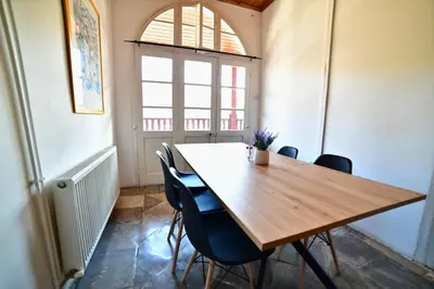 a dining room with a wooden table and chairs at Laouri Traditional 2-Bedroom in Kalopanayiotis in Kalopanayiotis