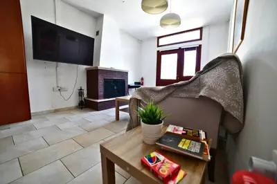 a living room with a couch and a fireplace at Laouri Traditional 2-Bedroom in Kalopanayiotis in Kalopanayiotis