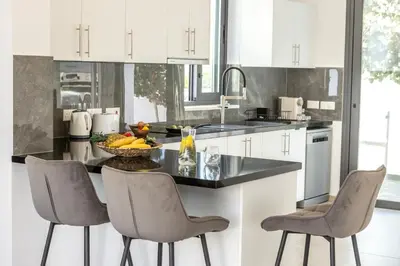 a kitchen with a bowl of fruit on a counter at Seaside Emerald in Paralimni