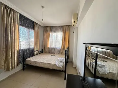 a bedroom with two bunk beds and two windows at Girne Merkez Daire in Aglantzia