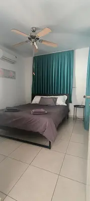 a bedroom with a bed with a ceiling fan at Efterpis12 St. House in Paralimni