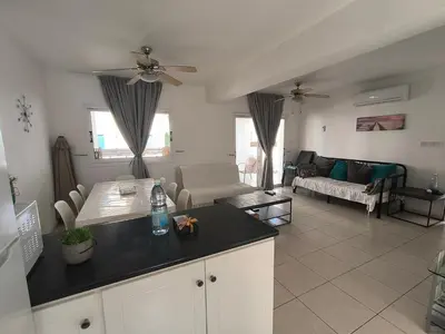 a kitchen and living room with a couch and a table at Efterpis12 St. House in Paralimni