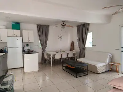 a kitchen and a living room with a couch and a table at Efterpis12 St. House in Paralimni