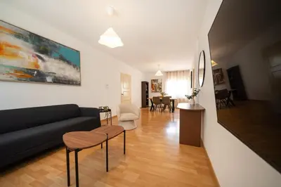 a living room with a black couch and chairs at 2 bedroom flat in city centre in Nicosia