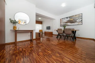 an empty living room with a table and chairs at Cozy 3 bedroom flat city center in Nicosia