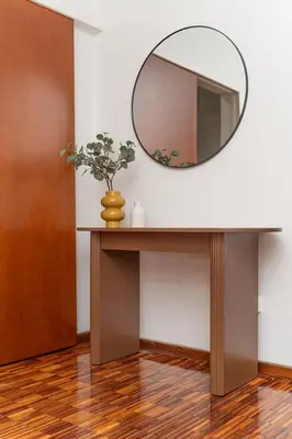 a mirror and a table with a vase on it at Cozy 3 bedroom flat city center in Nicosia