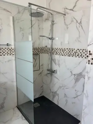 a shower with a glass door in a bathroom at Michaela's place in Aglantzia