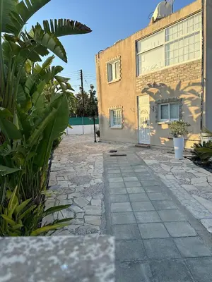 a building with a stone walkway in front of it at Modern house in Larnaca in Larnaka