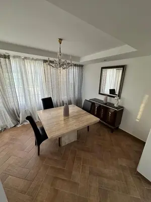 a dining room with a wooden table and chairs at Modern house in Larnaca in Larnaka