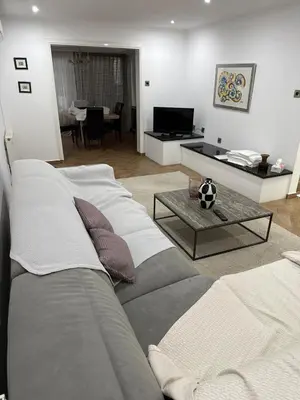 a living room with a couch and a table at Modern house in Larnaca in Larnaka