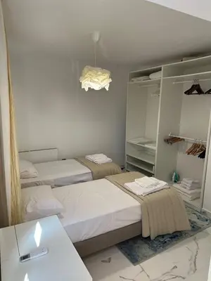 a bedroom with two beds and a mirror at Modern house in Larnaca in Larnaka