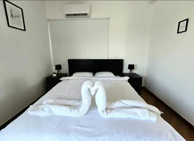 a bed with two pairs of white socks on it at Larnaca Villa in Sophtadhes