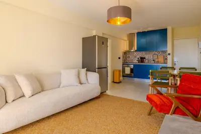 a living room with a couch and a kitchen at Seaview apartment newly renovated to high quality in Ayia Napa