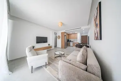 a living room with a couch and two chairs at Serene Gardens 2BR w Pool in Livadhia
