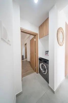 a laundry room with a washer and dryer in a house at Serene Gardens 2BR w Pool in Livadhia