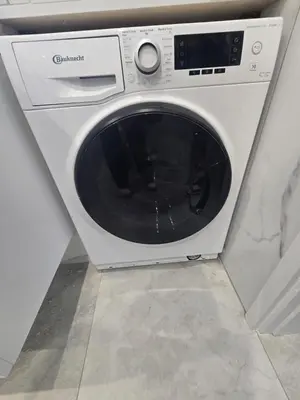 a white washing machine in a corner of a room at Lazuli Beachfront Sea View Ap 34 in Larnaka