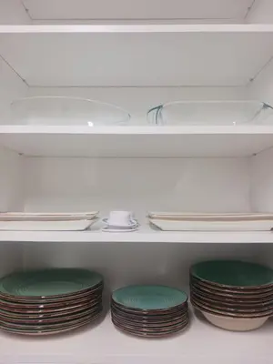 a group of plates and bowls on a shelf in a refrigerator at Lazuli Beachfront Sea View Ap 34 in Larnaka